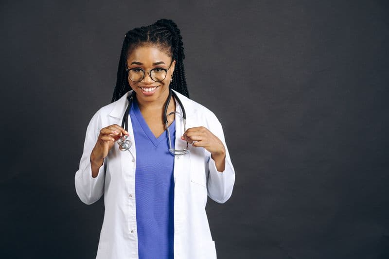 Portrait of Dr. Tasha Boyd, PT, DPT, GCS, smiling in a white coat